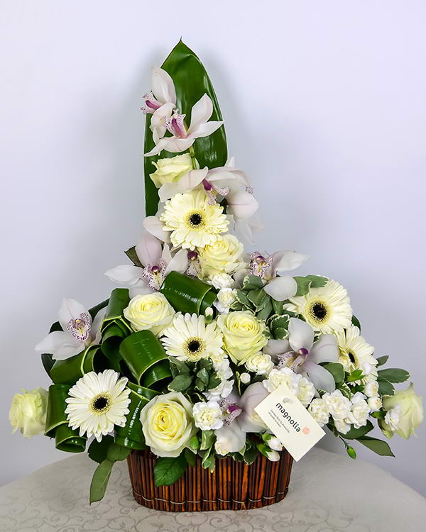 Arrangement with cymbidium orchid, roses and gerbera