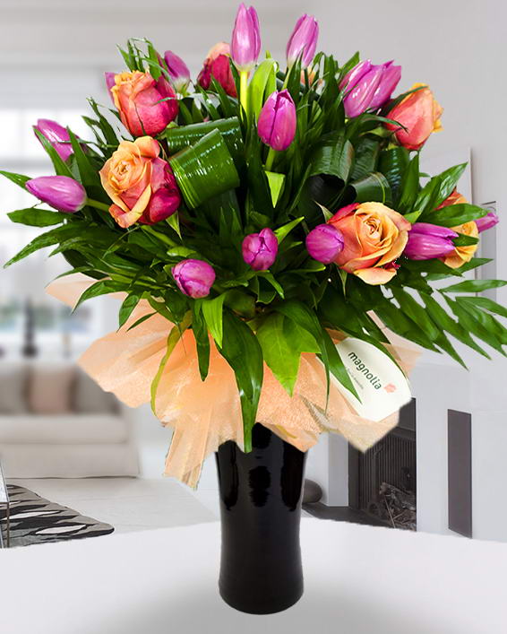 Bouquet with violet tulips, orange roses and aspidistra