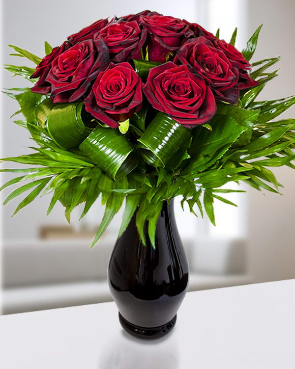 Bouquet with 11 red roses adorned with aspidistra