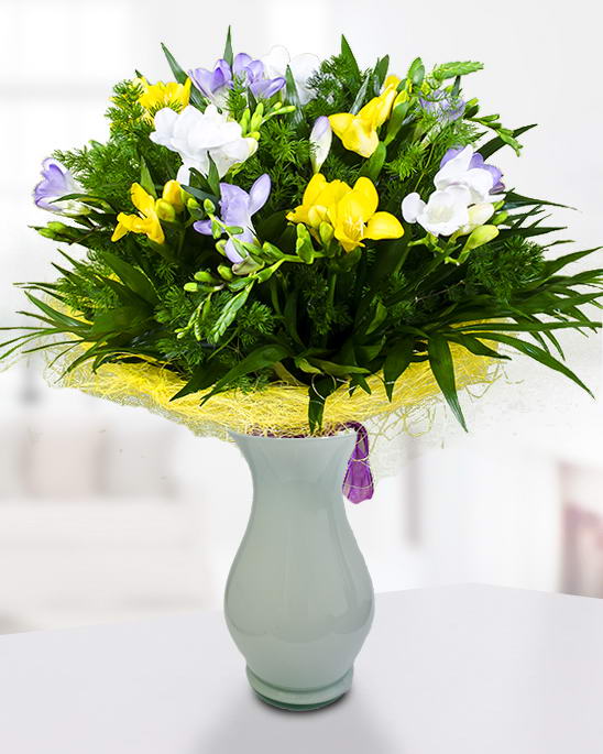Bouquet with 17 colorful freesias, asparagus and chico