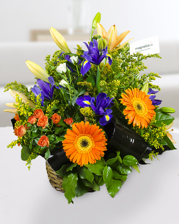 Basket arrangement with irises, gerbera, roses, lilies