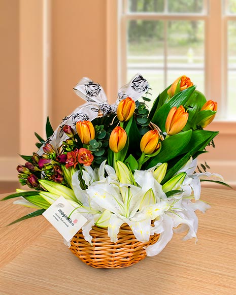 Basket arrangement with lilies, tulips and freesias