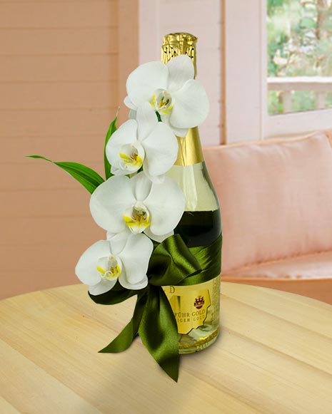 Arrangement with sparkling wine and orchid