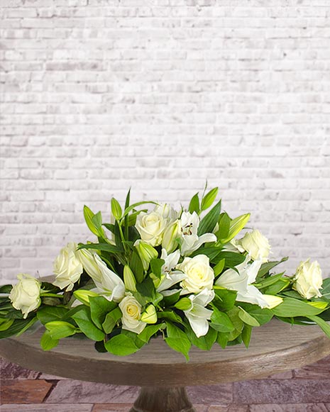 Funeral arrangement with lilies and roses