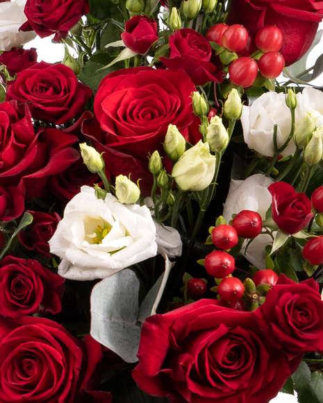 Bouquet of red roses and hypericum