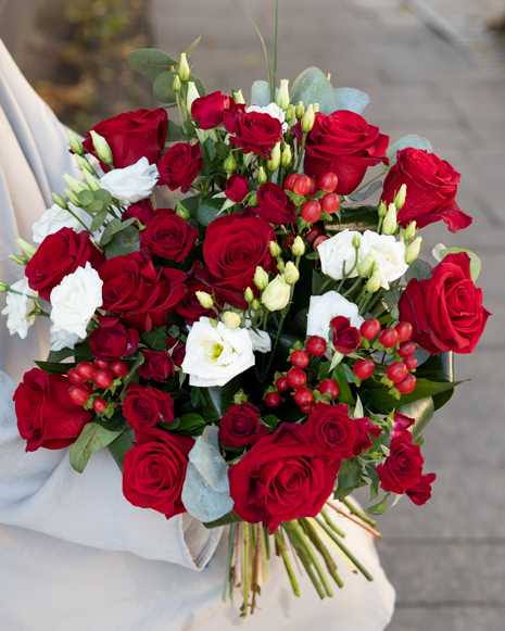 Bouquet of red roses and hypericum