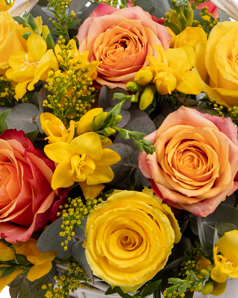 Freesias and roses basket arrangement