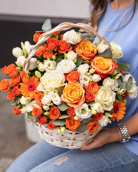 Basket of white and orange flowers