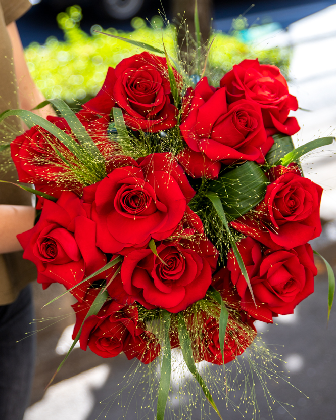 Bouquet of red roses and panicum