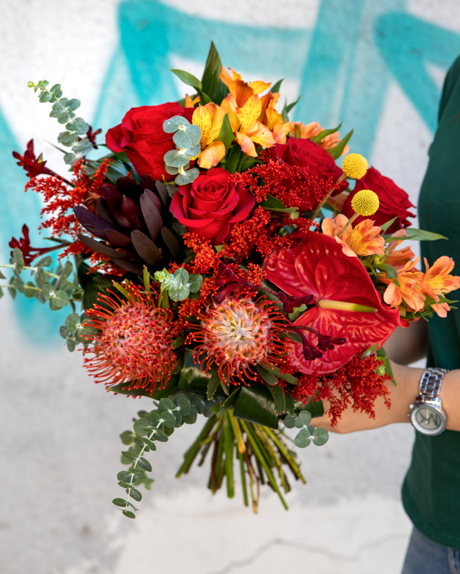 Bouquet with red roses and exotic flowers