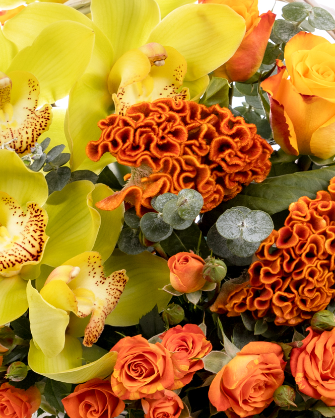 Basket with orange roses and orchid