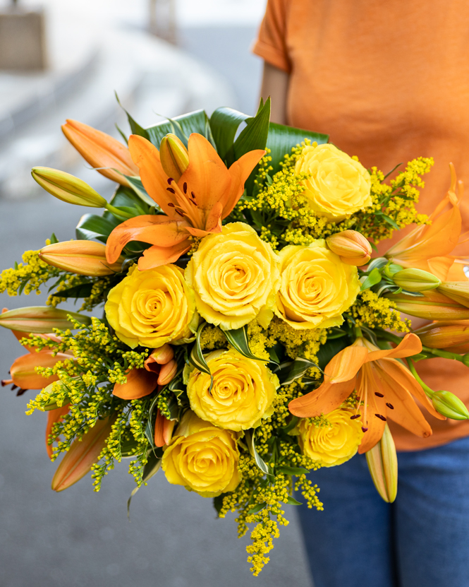 Bouquet of yellow roses and orange lilies