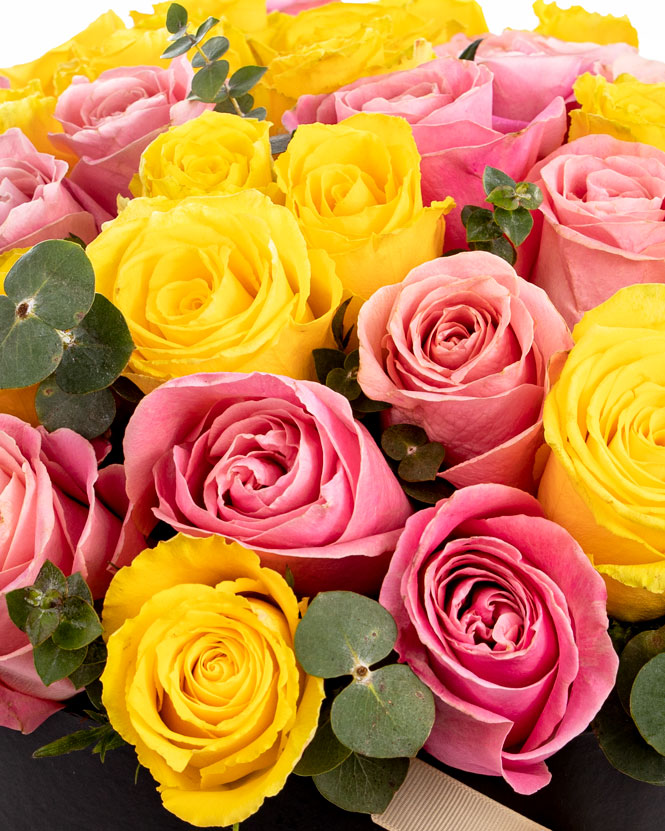 Box arrangement of pink and yellow roses