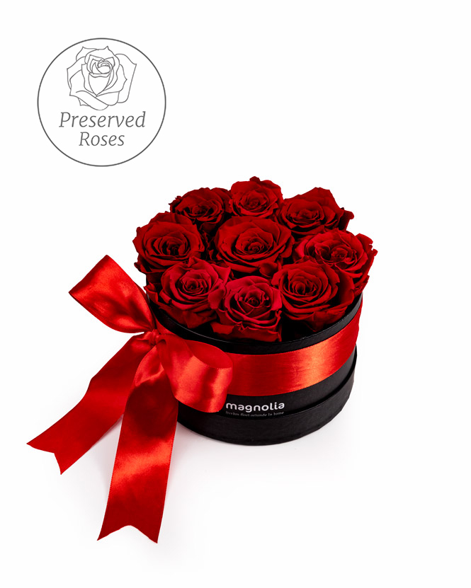 Preserved red roses in a black box
