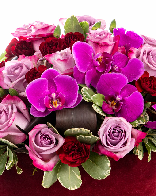 Orchids and roses in heart box