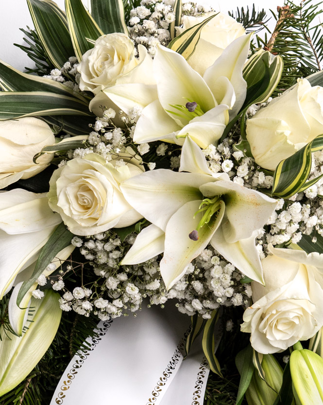 Funeral wreath with white roses and lilies