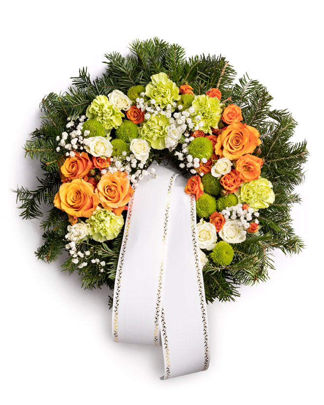 Funeral wreath with orange roses and carnations