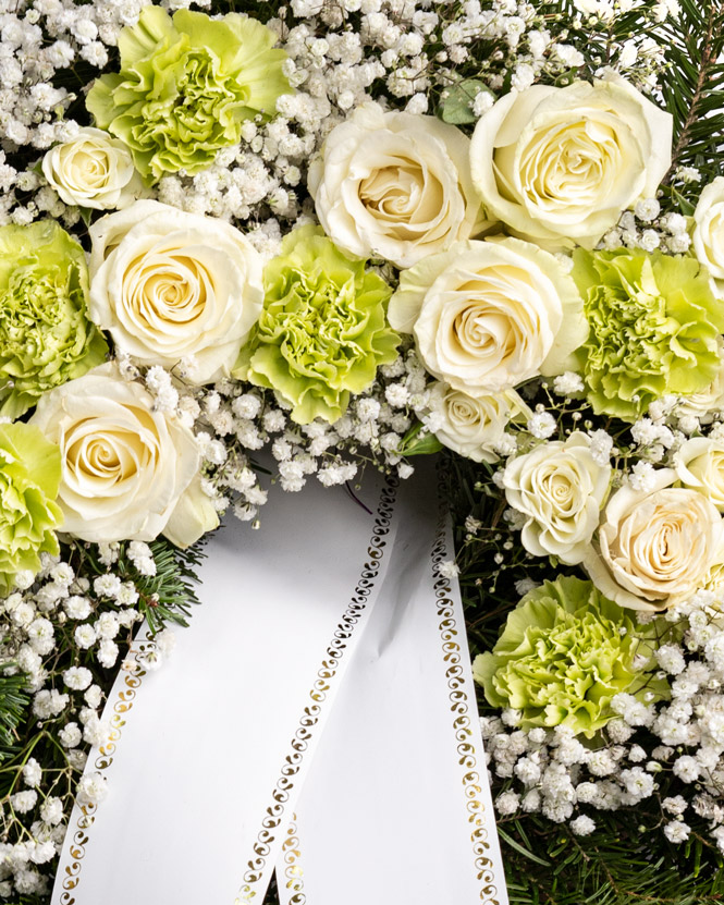 Funeral wreath with white roses and carnations