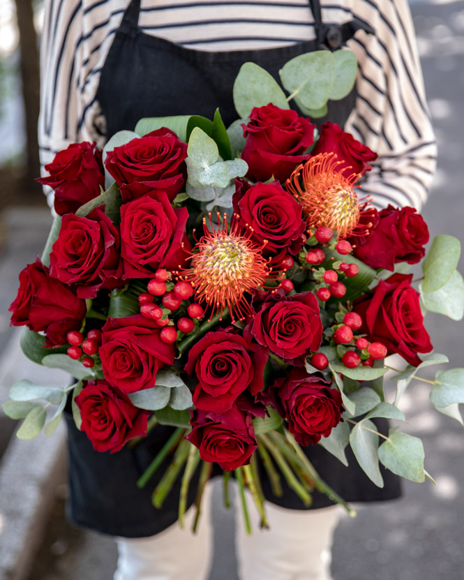 Bouquet with red roses and leucospermum