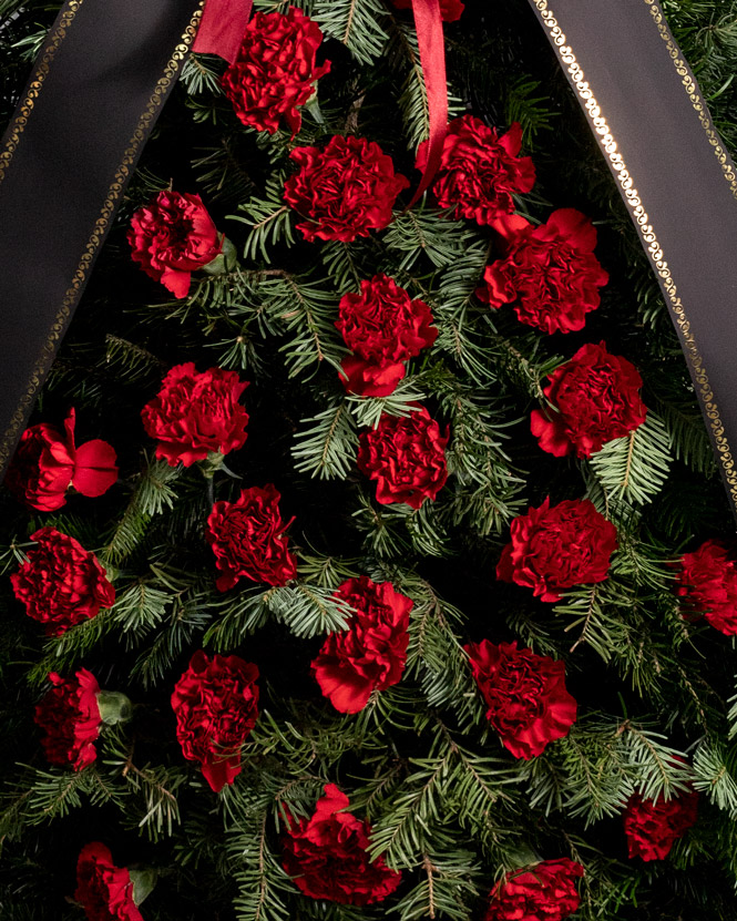 Funeral spray with red carnations