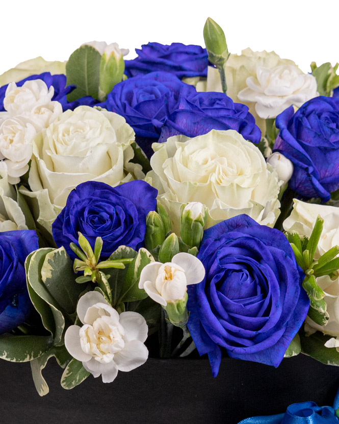 Arrangement with blue and white roses