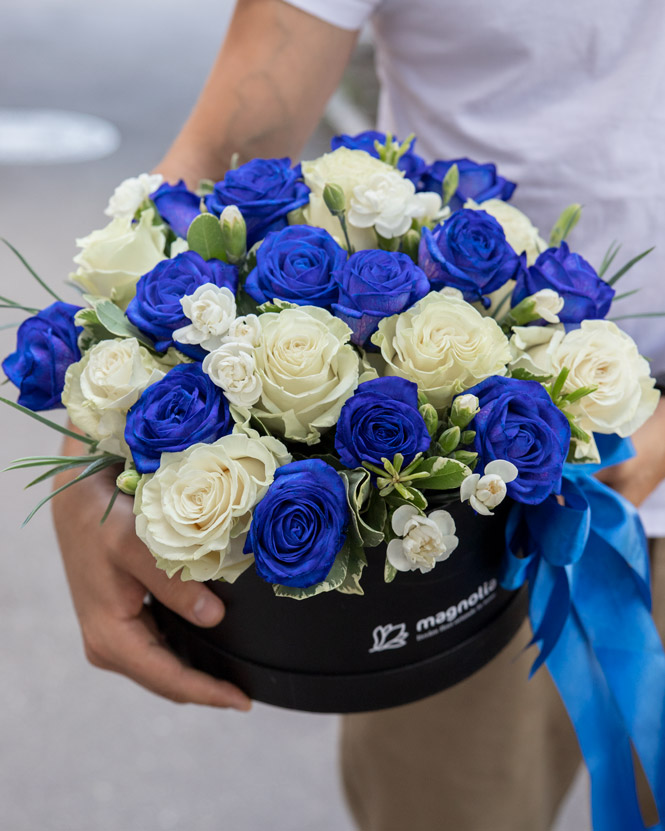 Arrangement with blue and white roses