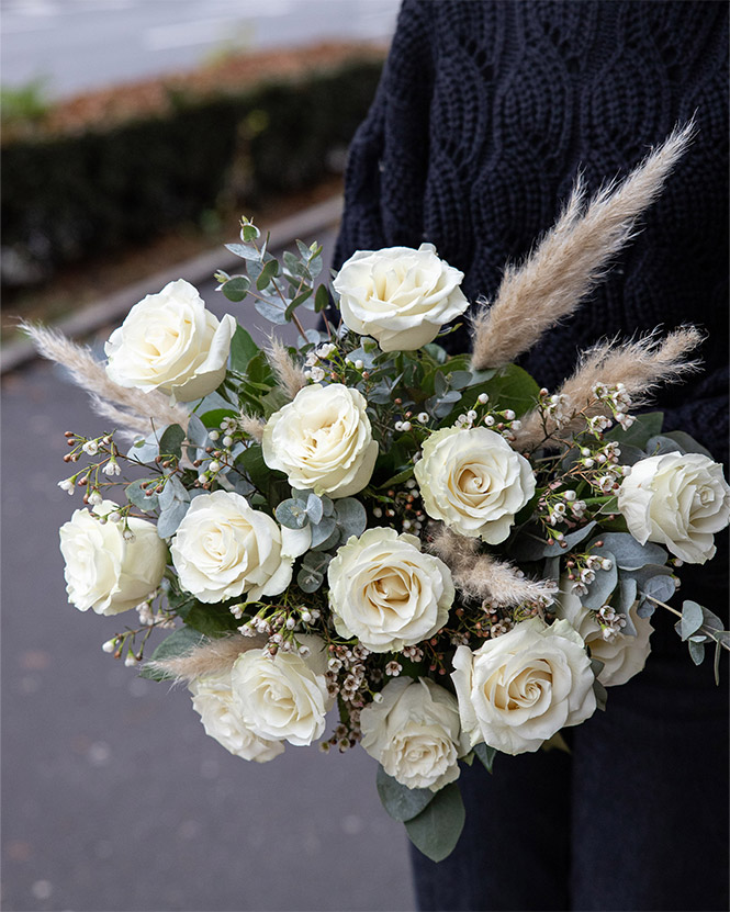 White roses bouquet decorated with pampas grass