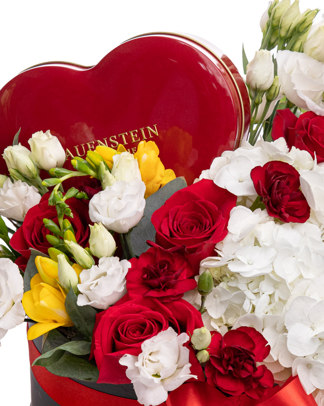 Arrangement with roses, hydrangea and chocolate