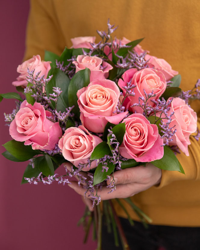 Pink roses bouquet decorated with greenery