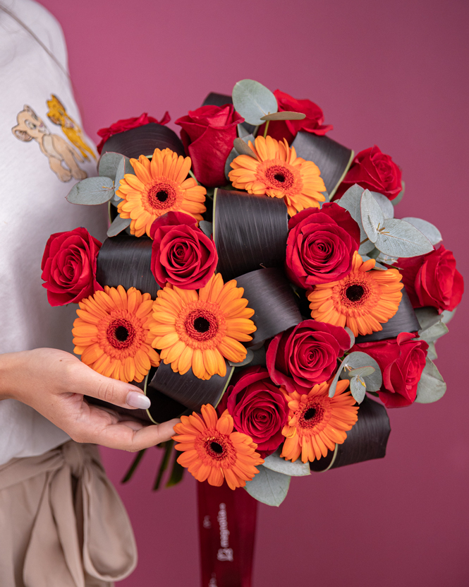 Bouquet with red roses and orange gerberas