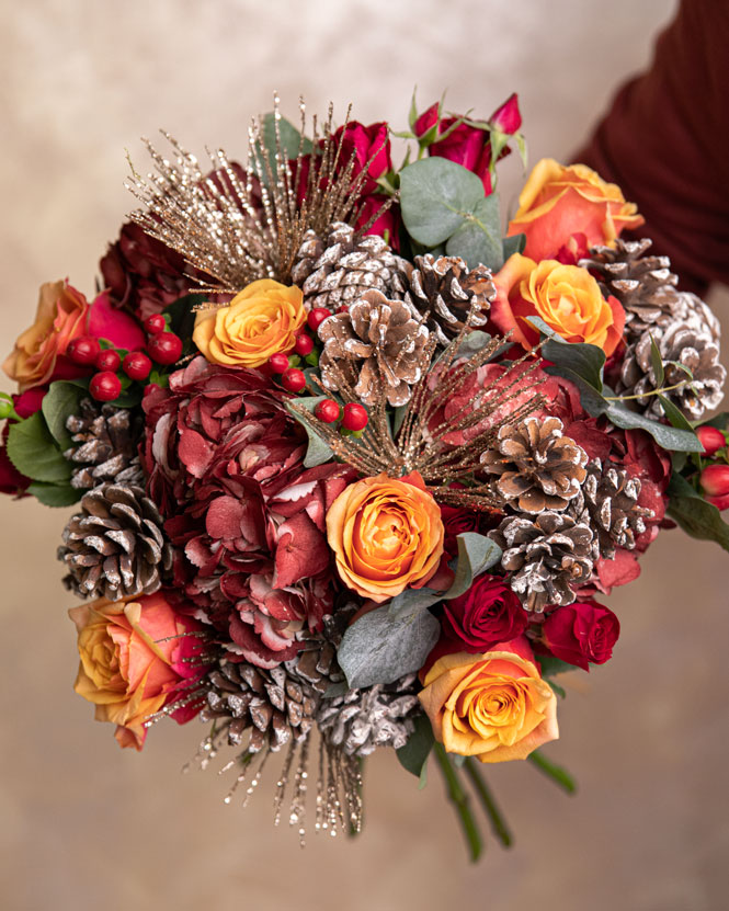 Winter bouquet with roses and pine cone