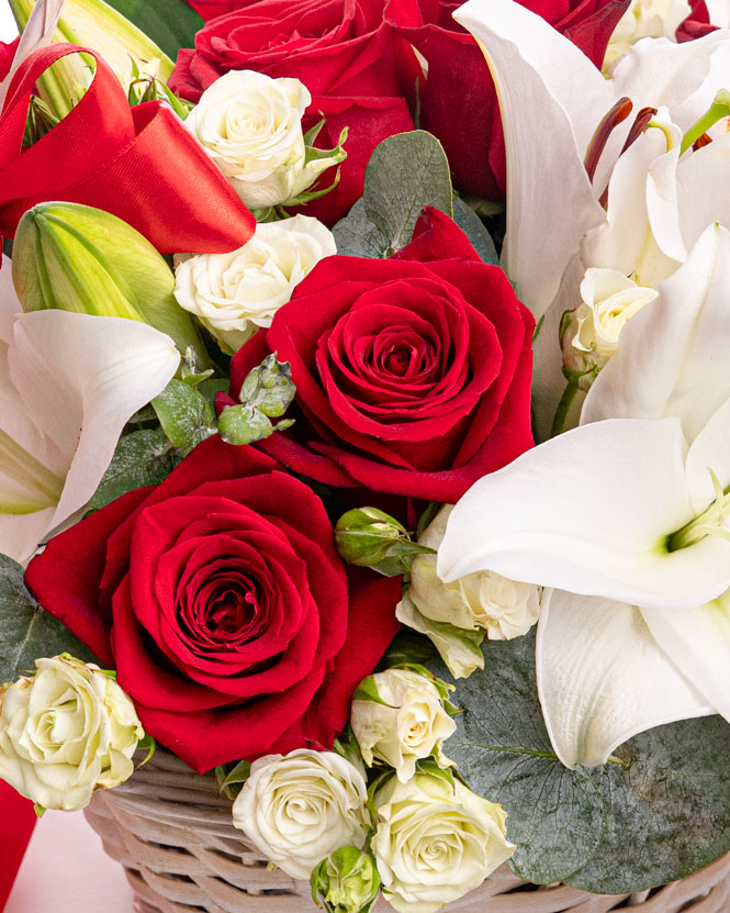 Basket with white lilies and red roses