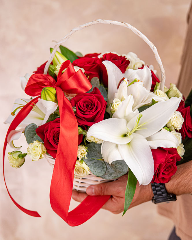 Basket with white lilies and red roses