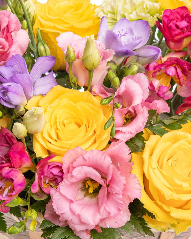 Freesias and roses basket arrangement