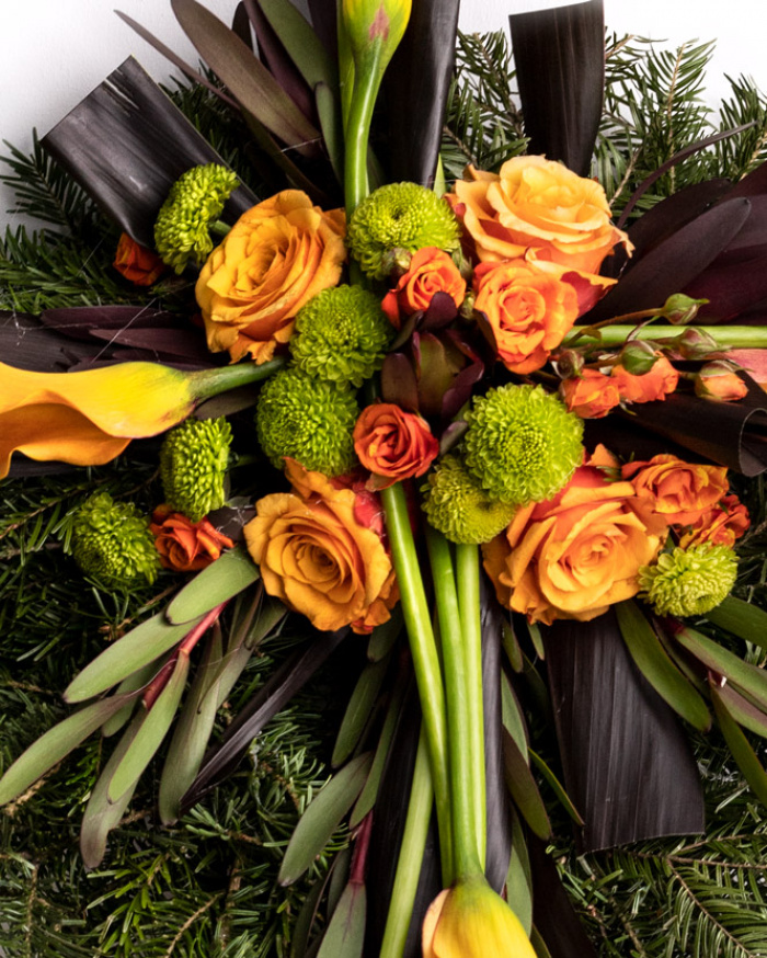 Funeral wreath with orange roses and callas