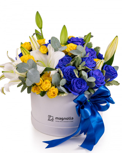 Arrangement in box with blue and yellow roses