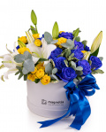 Arrangement in box with blue and yellow roses