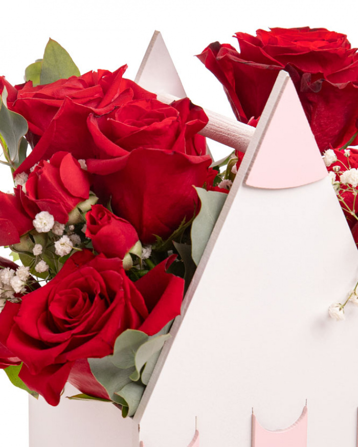 Prim-plan al florilor din aranjamentul “Aranjament cu trandafiri „Back to School””, varianta Premium, evidentiind combinatia armonioasa de 7 Trandafiri roșii, 2 Trandafiri ramificați roșii, 1 Gypsophila, completate de 1 crenguță de Eucalipt si finisate cu o cutie creion eleganta.