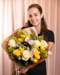 Perspectivă care evidențiază proporțiile și dimensiunea buchetului “Buchet trandafiri și alstroemeria”, varianta Premium, o compoziție bogată alcătuită din 5 Trandafiri albi, 4 Trandafiri ramificați galbeni, 1 Alstroemeria, 2 fire de Chamelaucium alb, 3 fire de Solidago și 3 crenguțe de Eucalipt, finisată elegant cu ambalaj decorativ și o panglică Magnolia.